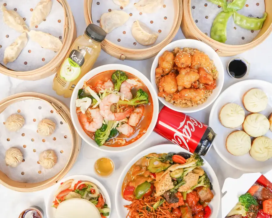 A Mama Bao Catering spread with dumplings, noodles and wok dishes