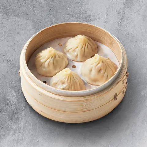Xiao long bao in a bamboo steamer